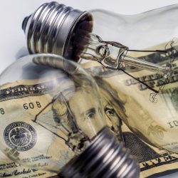 A lightbulb on dollar bill, energy saving concept
