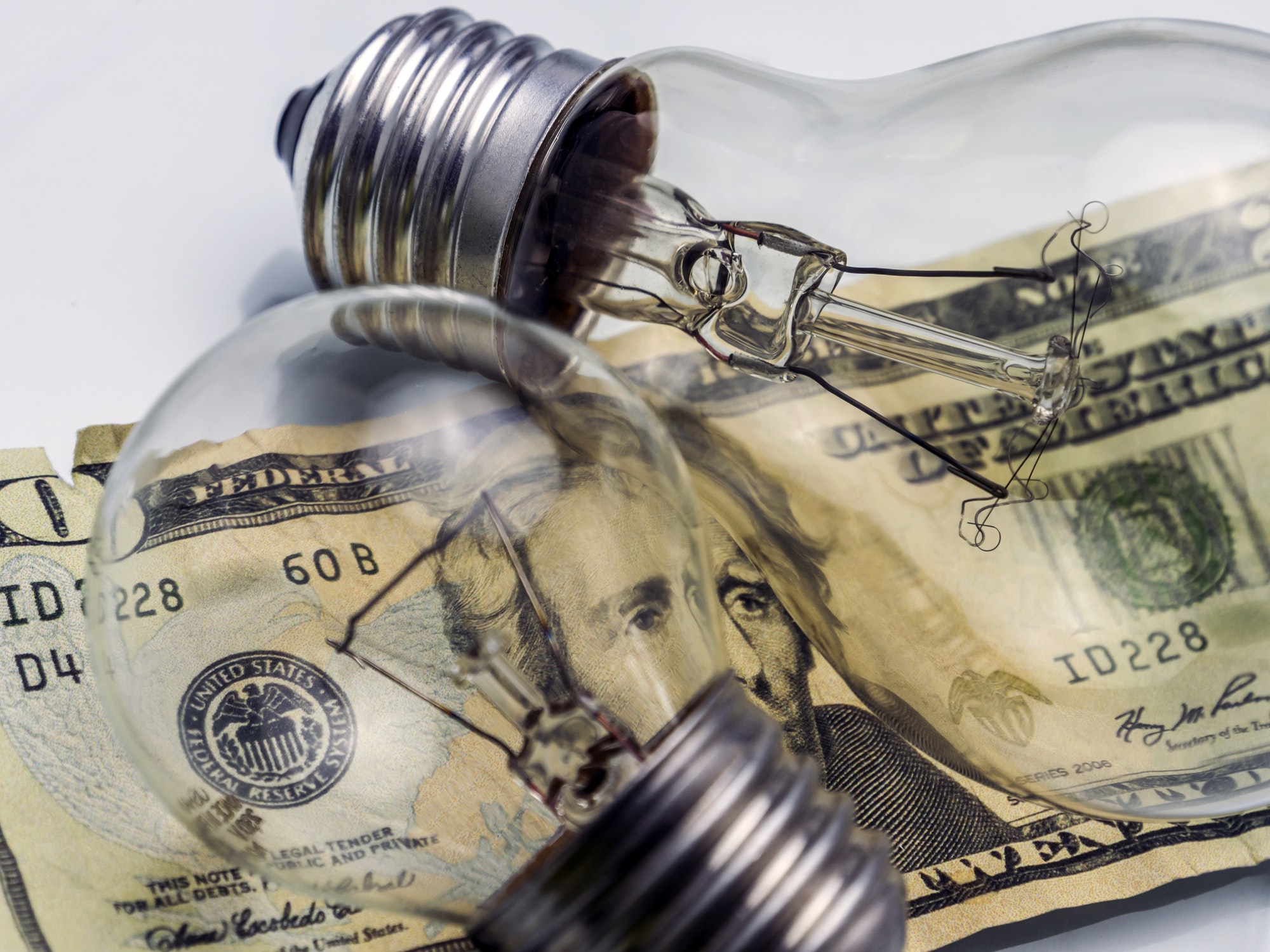 A lightbulb on dollar bill, energy saving concept