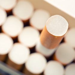 Close up of pack full of cigarettes with one cigarette chosen
