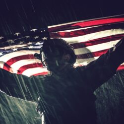 Proud American Army Soldier with National Flag in Hands During Heavy Thunderstorm and Rainfall. United States of America. Victory Concept. Military Theme.