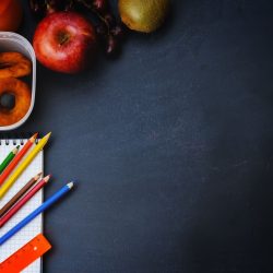 School background with school lunch, pencils and a notebook. the toning. selective focus