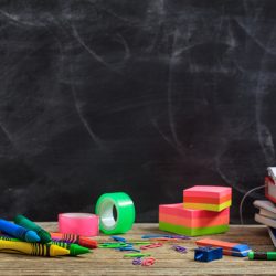 Education concept - School supplies on a wooden desk