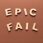 Wooden letters spelling Epic fail on brown background